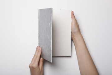 woman hand hold a book(note) isolated white.