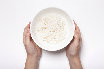 woman hand hold a rice noodle isolated white.