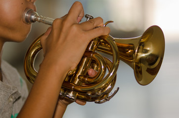 .Children learn to play trumpet happily. © Tongra