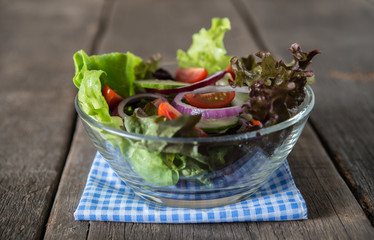 Close up of fresh vegetables salad in the bowl. Healthy food concept.