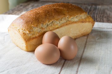 bread baked in the oven and eggs on the table