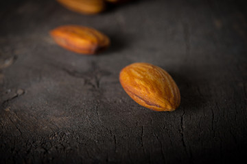 Almonds on wooden background.