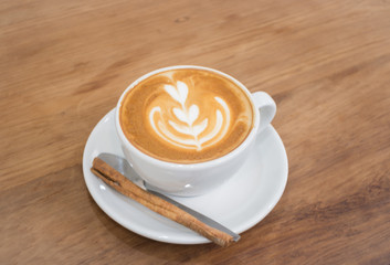 Coffee With Latte Art On Wooden Table