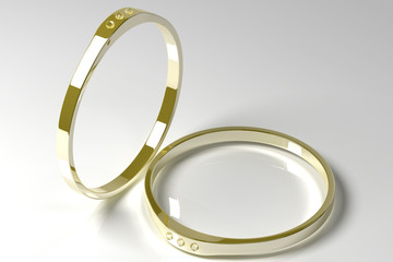 Two golden rings with diamonds on a grey background