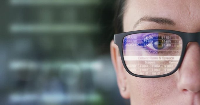 The future business girl looks into the hologram, monitors trade, finances, volition, sales and purchases,in the office.Concept:career growth,business affairs,future savings,logistics,broker,marketing