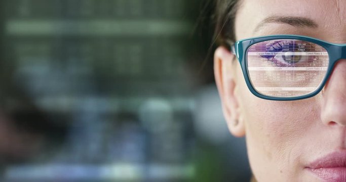 The future business girl looks into the hologram, monitors trade, finances, volition, sales and purchases,in the office.Concept:career growth,business affairs,future savings,logistics,broker,marketing