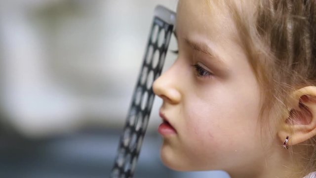 eye test child patient, face closeup
