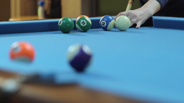 Woman Missing Pool Shot on Blue Billiards Table