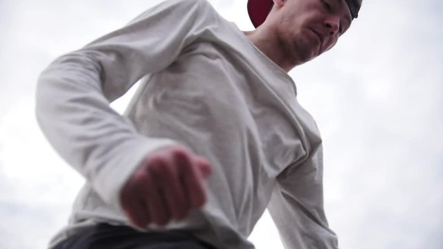 Slow motion - acrobatic parkour teenager doing backflip outdoor