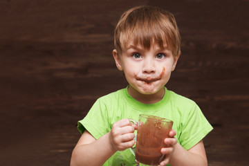 the kid drinks cocoa at home.