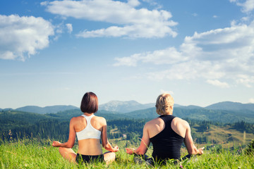 Beautiful young woman and man doing yoga exercise