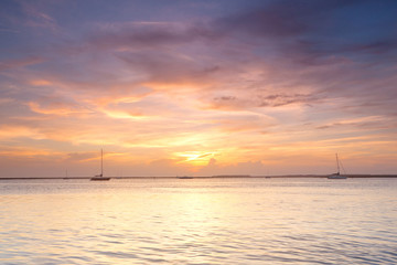 Fototapeta na wymiar Yachts in the ocean at sunset