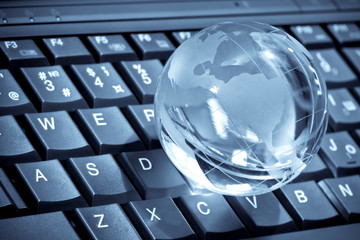 glass globe on a laptop keyboard