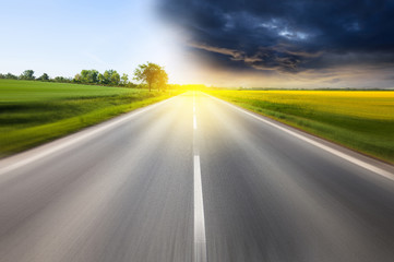 Driving to the sunny and stormy clouds horizon
