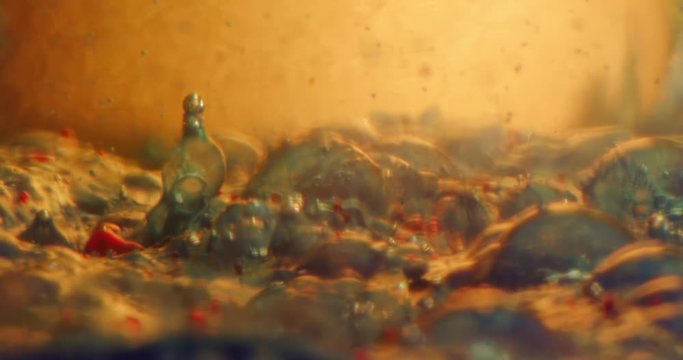 Stars wars of the planet.Color drops floating in oil and water over a colorful underground with oil painting effect. 4K.
