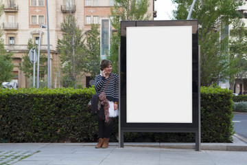 Blank billboard and woman with mobile - obrazy, fototapety, plakaty