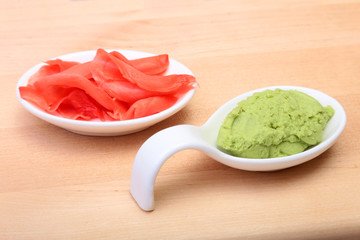 Bowl with Wasabi and ginger on wooden background. Japanese cuisine. Asia food.