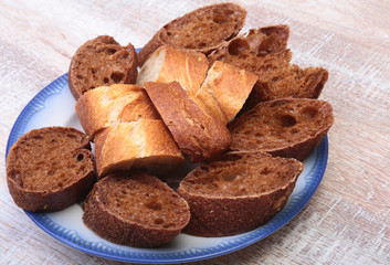 Sliced bread Ciabatta with plate on cutting board on wooden background
