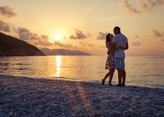 Fototapeta premium Young couple in love sitting on the beach