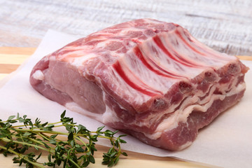 Raw pork chops, spices and rosemary on cutting board. Ready for cooking.