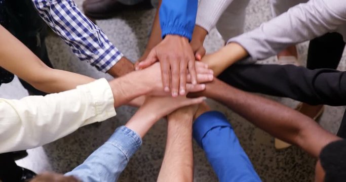 Hands of business team stacking their hands together