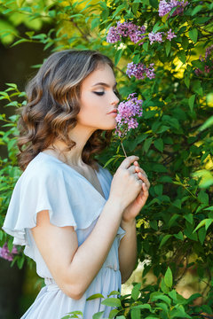 curly haired girl dressed in white gown