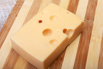 Fototapeta na wymiar Italian piece of cheese on a wooden cutting board