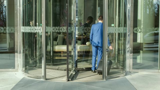 Businessman entering modern five-star hotel