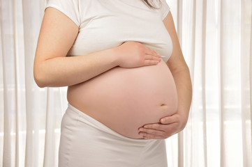 woman holding her pregnant belly