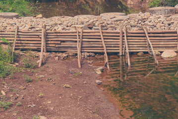 Fototapeta na wymiar man made weir(small dam) across river