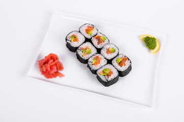Asia. Rolls with salmon (red fish) on a white plate on a white background