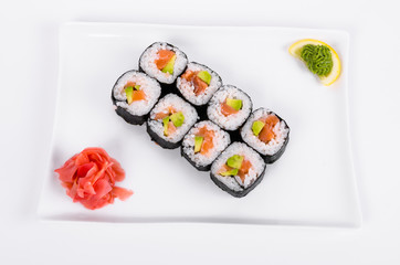 Asia. Rolls with salmon (red fish) on a white plate on a white background