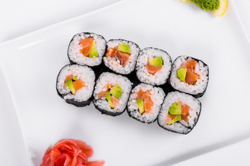 Asia. Rolls with salmon (red fish) on a white plate on a white background