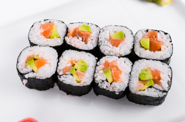 Asia. Rolls with salmon (red fish) on a white plate on a white background