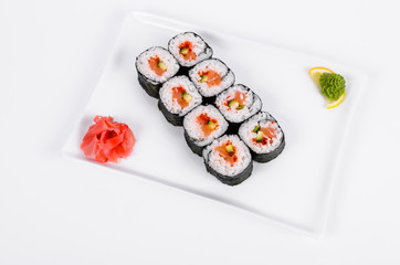 Asia. Rolls with salmon (red fish) on a white plate on a white background
