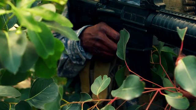 Military man praticing to shoot with a gun in the boot camp