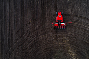 Aerial view of tractor working on the harvest field