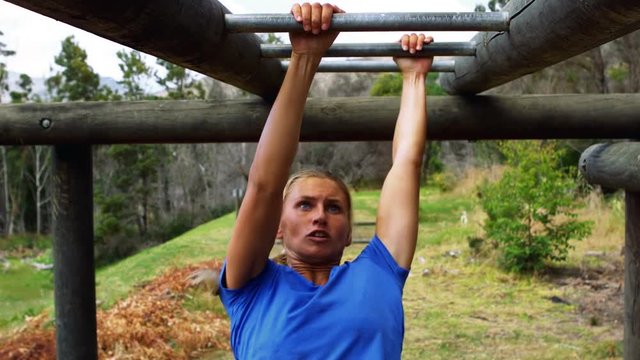 Woman Crossing The Monkey Bars During Obstacle Course