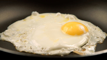 Fried eggs on the pan - Side view