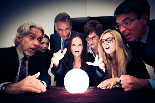 Business Team Using A Crystal Ball To Look Into Future
