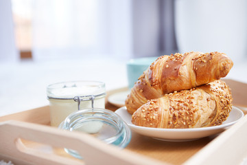 breakfast in bed with coffee and croissants