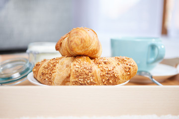 breakfast in bed with coffee and croissants