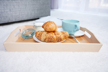 breakfast in bed with coffee and croissants