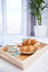 breakfast in bed with coffee and croissants