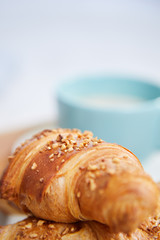 breakfast in bed with coffee and croissants