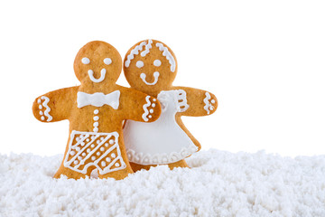 Gingerbread cookies, gingerbread men  in the snow isolated on white background, christmas or new year background, greeting card template