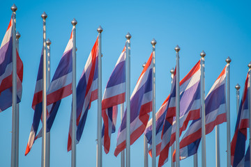Flag of Thailand with blue sky.