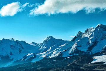 Snow capped mountains. Summits of the mountains. View of the Alpine mountains at the sunrise. Trek near Matterhorn mount.