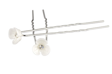 Two metallic hairpins with white plastic flowers and one diamond in the middle, isolated on white background, clipping path included