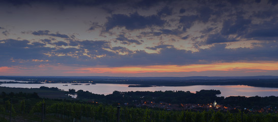 Sunset over Moravian dam and vineyards in the early evening